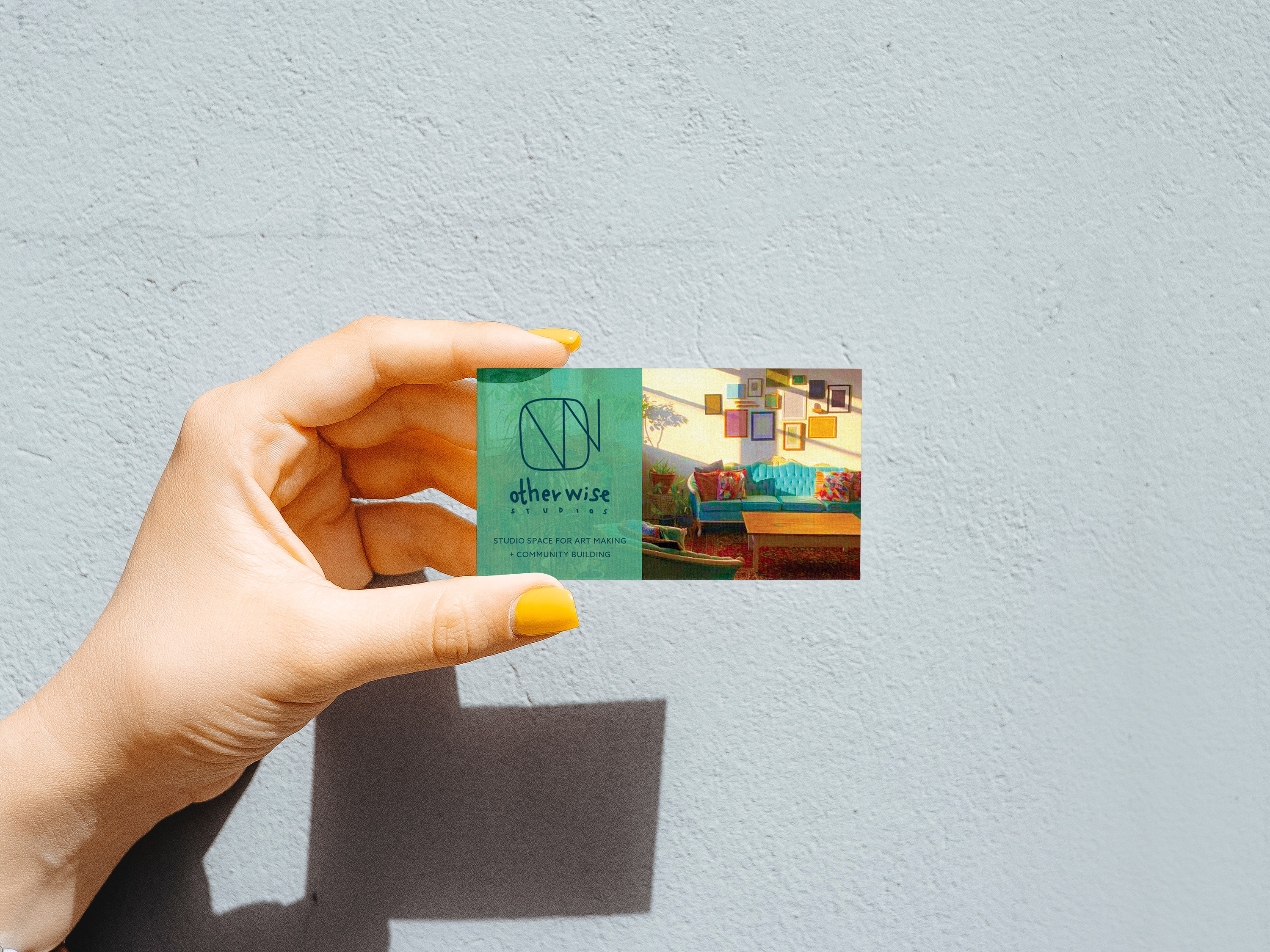 A hand holding a business card.